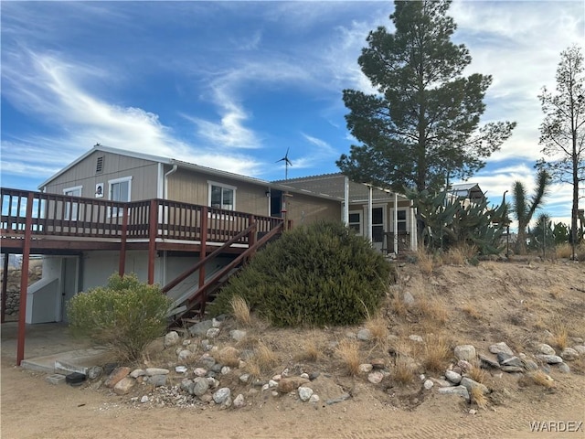 view of property exterior with a wooden deck