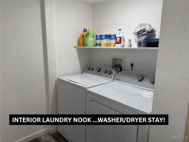 laundry room featuring a textured wall and washing machine and dryer