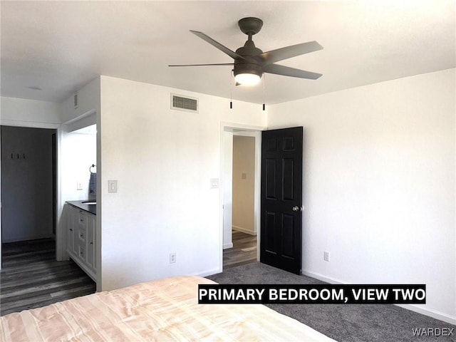 unfurnished bedroom featuring baseboards, visible vents, and dark wood-style flooring