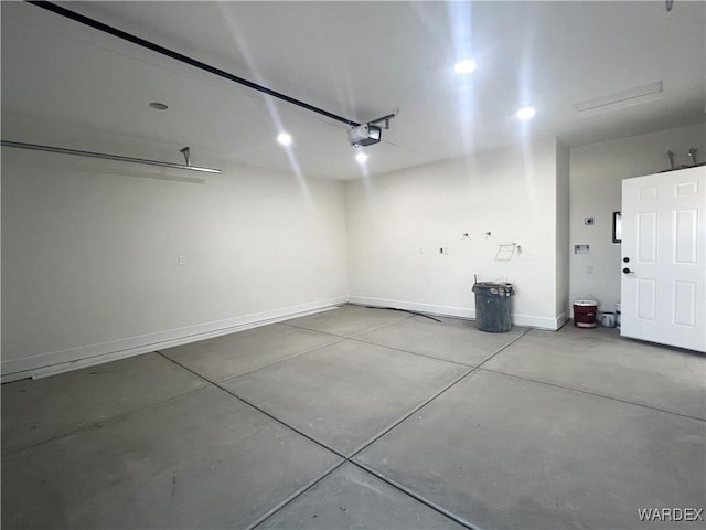 garage with baseboards and a garage door opener