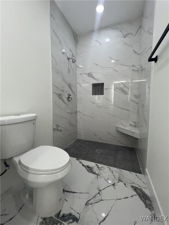 bathroom with marble finish floor, toilet, and a marble finish shower