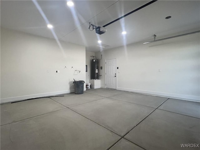 garage with a garage door opener, electric water heater, and baseboards