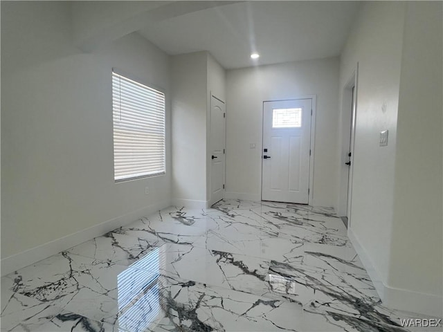 entrance foyer with marble finish floor, recessed lighting, a wealth of natural light, and baseboards