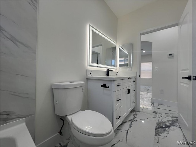 bathroom featuring marble finish floor, baseboards, vanity, and toilet