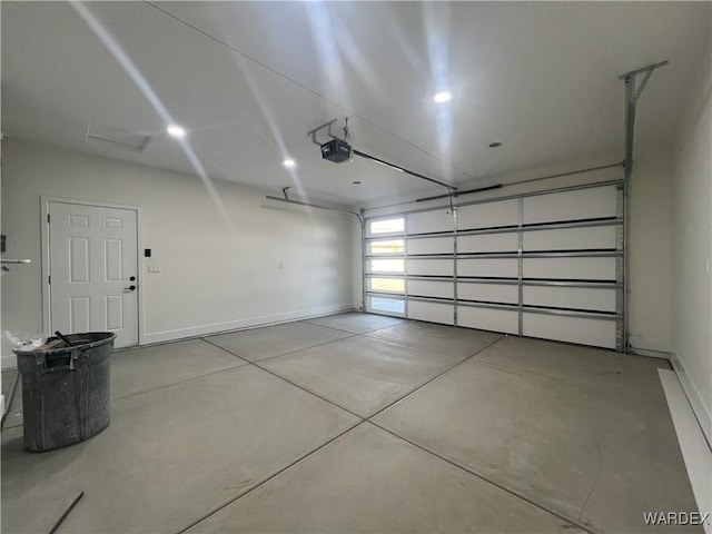 garage with a garage door opener and baseboards