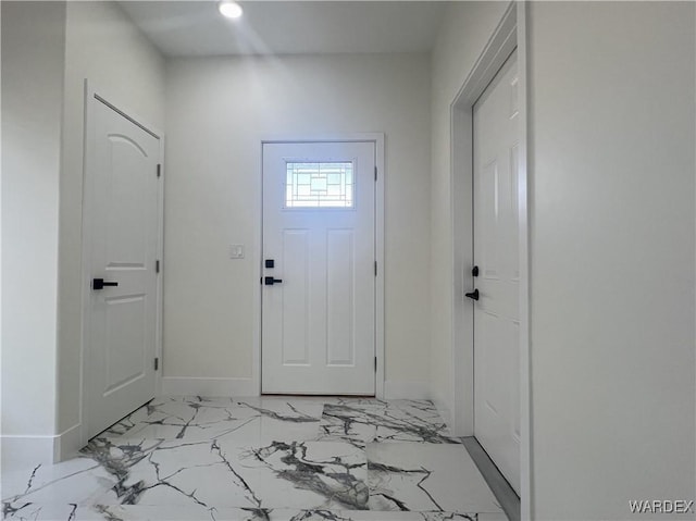 foyer entrance featuring marble finish floor, recessed lighting, and baseboards