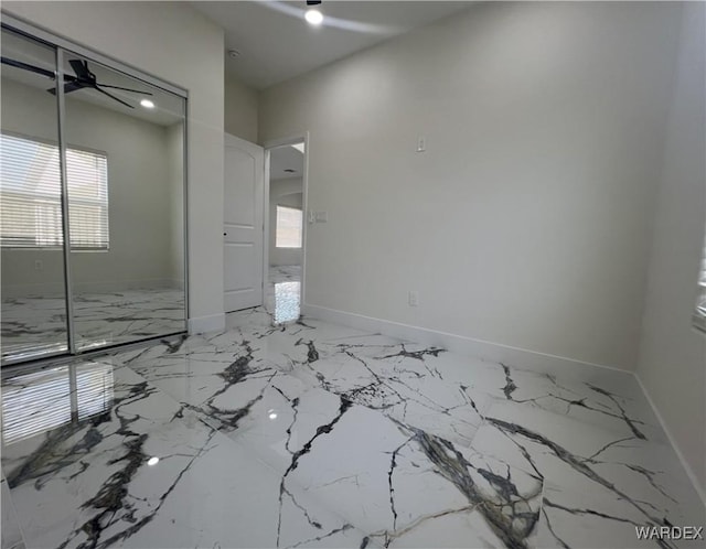 unfurnished bedroom with baseboards, a closet, and recessed lighting