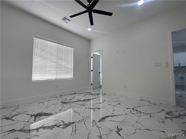 unfurnished room featuring recessed lighting, marble finish floor, visible vents, and baseboards