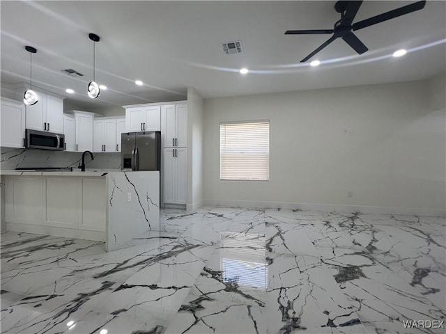 kitchen featuring hanging light fixtures, appliances with stainless steel finishes, visible vents, and white cabinets