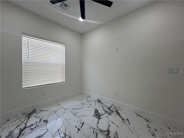 unfurnished room featuring baseboards, visible vents, and a ceiling fan