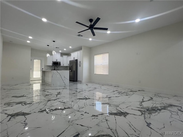 unfurnished living room with a healthy amount of sunlight, baseboards, a ceiling fan, and recessed lighting