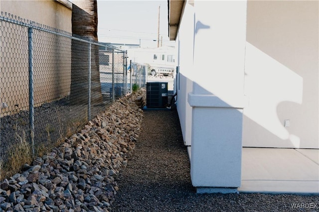 view of home's exterior featuring fence and central AC unit