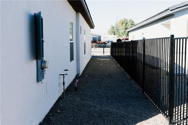 view of property exterior with fence and stucco siding