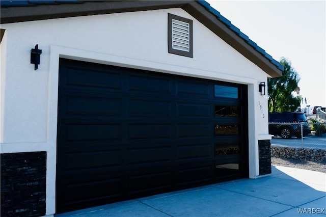 garage with fence