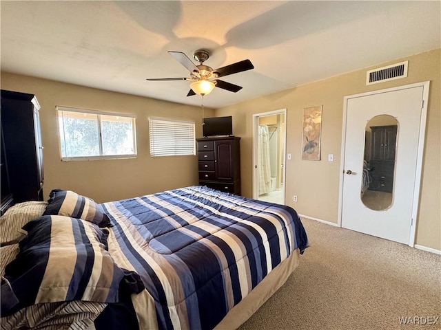 bedroom featuring baseboards, visible vents, ceiling fan, ensuite bathroom, and carpet flooring