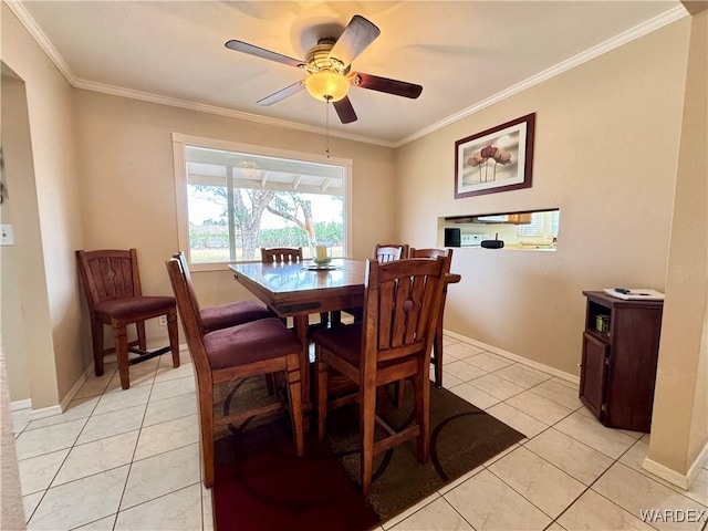 dining room featuring light tile patterned floors, baseboards, ceiling fan, and crown molding