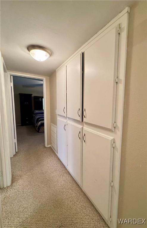 corridor with light colored carpet