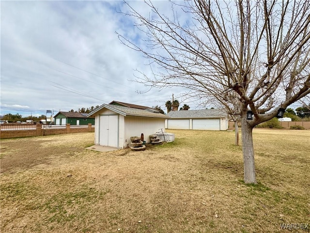 view of yard with an outbuilding and fence