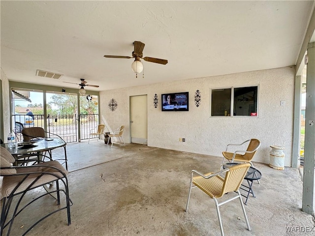 sunroom / solarium with visible vents and a ceiling fan