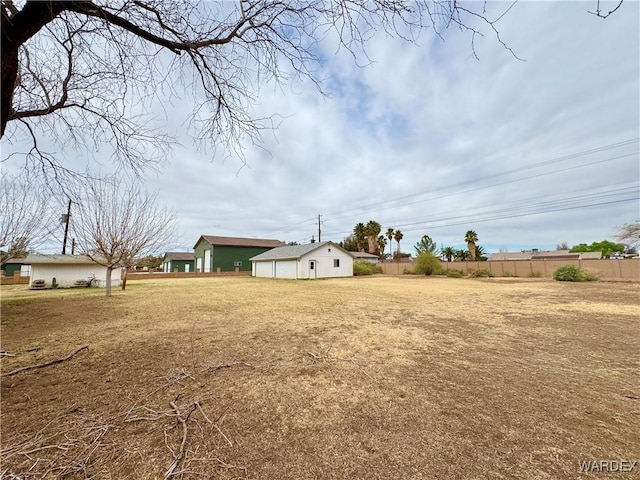 view of yard with an outdoor structure and fence