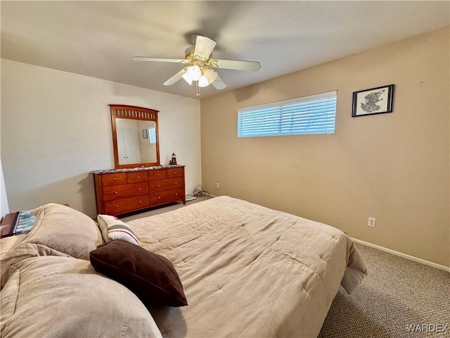 carpeted bedroom with baseboards and a ceiling fan