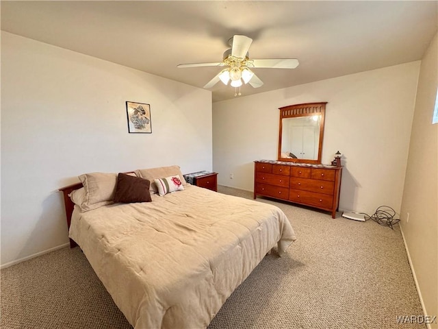 bedroom featuring light carpet, baseboards, and a ceiling fan