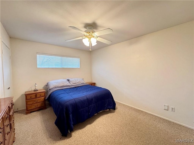 bedroom with a ceiling fan, light colored carpet, and baseboards