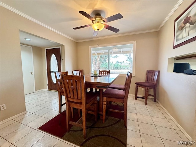 dining area with light tile patterned flooring, a ceiling fan, baseboards, and ornamental molding