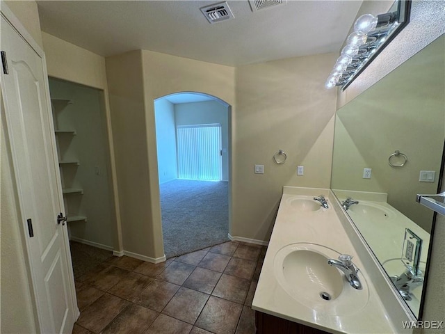 full bathroom featuring a sink, baseboards, tile patterned floors, and visible vents