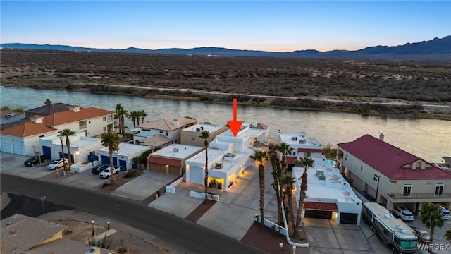 drone / aerial view with a residential view and a water and mountain view