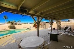 view of patio with a storage shed, an outdoor structure, a fenced backyard, and a fenced in pool