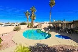 pool featuring a patio area and fence