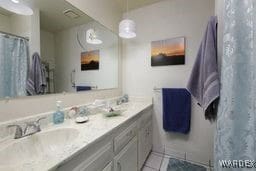 bathroom featuring visible vents, curtained shower, tile patterned flooring, and vanity