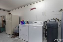 laundry room featuring ornamental molding, washing machine and dryer, and laundry area