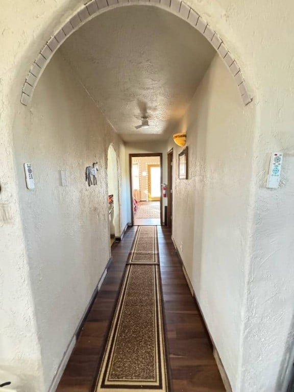 18000 Laurel Rd, Dolan Springs, AZ 86441 - hall with a textured wall, dark wood finished floors, and arched walkways
