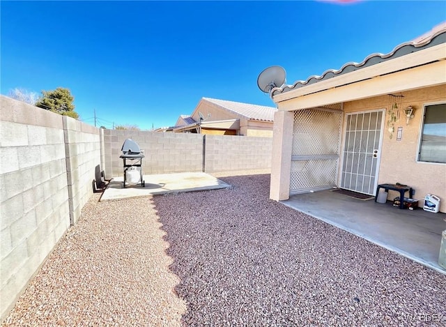 view of yard with a patio area and a fenced backyard