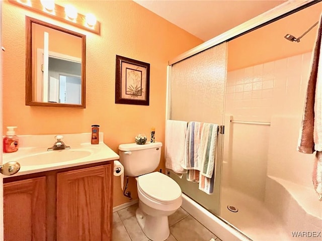 full bathroom with toilet, a shower with shower door, vanity, and tile patterned floors