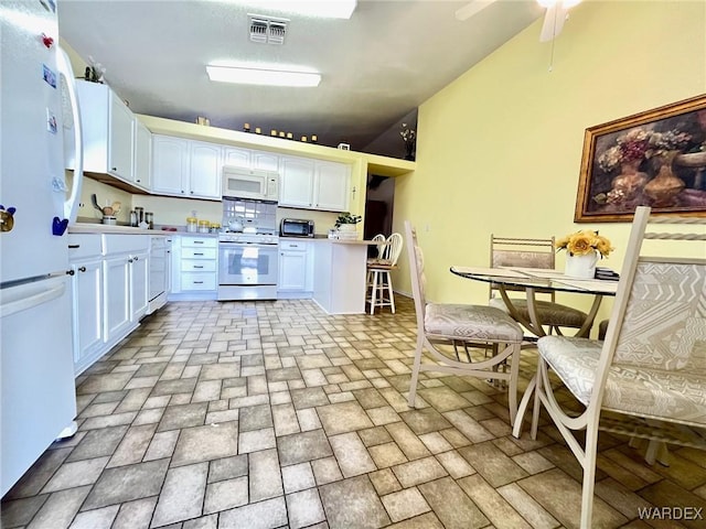 kitchen with light countertops, visible vents, a ceiling fan, white cabinetry, and white appliances