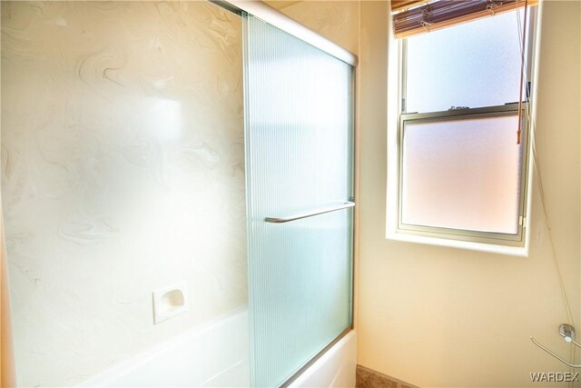 full bathroom with bath / shower combo with glass door