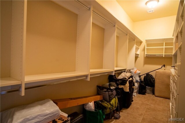 spacious closet featuring light tile patterned flooring and visible vents