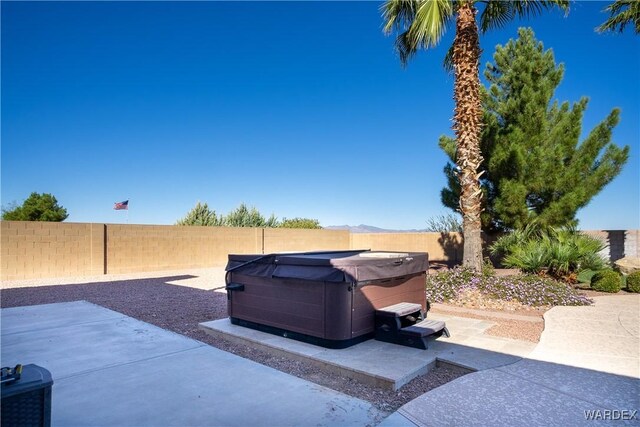 view of patio featuring a fenced backyard and a hot tub