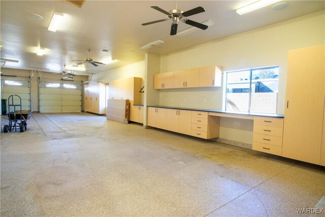 garage with a garage door opener and a ceiling fan