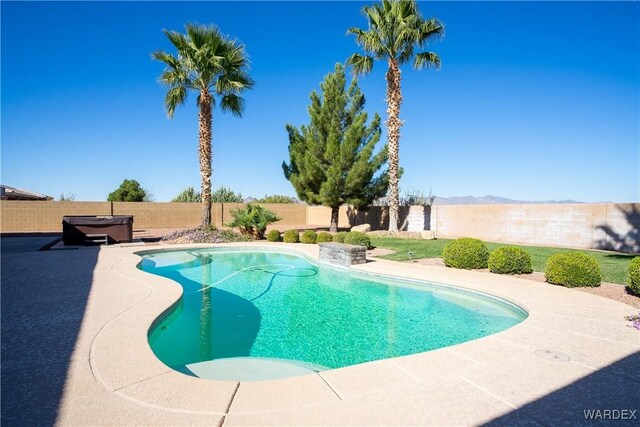 view of swimming pool with a fenced backyard, a mountain view, a fenced in pool, and a patio