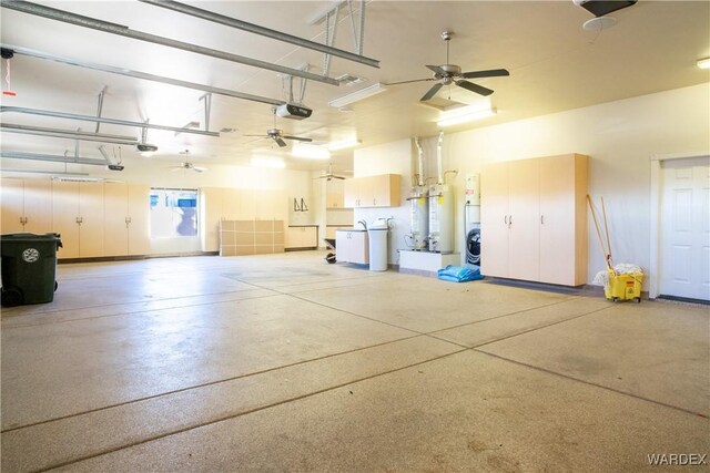 garage with a garage door opener, water heater, and ceiling fan