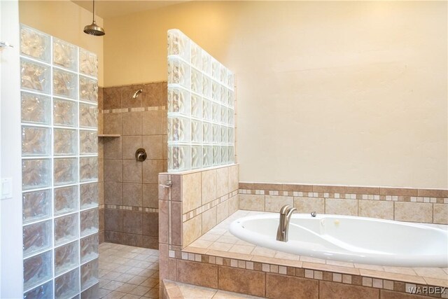 full bathroom with a garden tub and a walk in shower