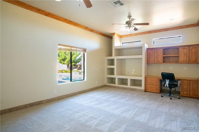 unfurnished office featuring ornamental molding, built in study area, visible vents, and light colored carpet