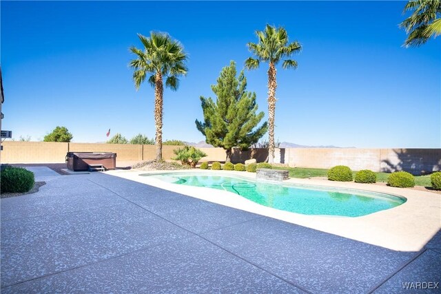 view of swimming pool featuring a fenced in pool, a patio area, a fenced backyard, and a hot tub