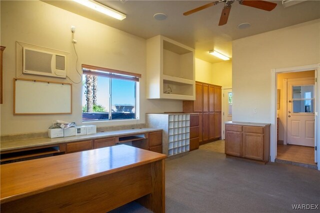 kitchen featuring brown cabinets, light countertops, an AC wall unit, carpet flooring, and open shelves