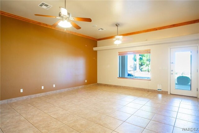 spare room with visible vents, crown molding, baseboards, and light tile patterned floors