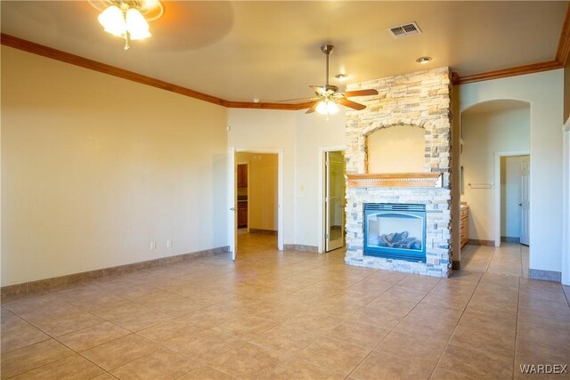 unfurnished living room featuring a fireplace, crown molding, visible vents, a ceiling fan, and baseboards